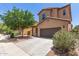 Attractive two-story home featuring a two car garage and lush landscaping at 4051 E Torrey Pines E Ln, Chandler, AZ 85249