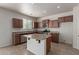 This kitchen features granite counters, wood cabinets, stainless appliances and an island at 4051 E Torrey Pines E Ln, Chandler, AZ 85249