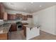 Well-equipped kitchen with stainless steel appliances, granite counters, and a functional island at 4051 E Torrey Pines E Ln, Chandler, AZ 85249