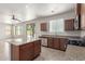 This kitchen features granite counters, wood cabinets, stainless appliances, and an island at 4051 E Torrey Pines E Ln, Chandler, AZ 85249