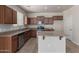This kitchen features granite counters, wood cabinets, stainless appliances and an island at 4051 E Torrey Pines E Ln, Chandler, AZ 85249
