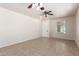 Open-concept living room featuring tile flooring and ceiling fan at 4051 E Torrey Pines E Ln, Chandler, AZ 85249