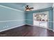 Spacious bedroom with hardwood floors, ceiling fan, and sliding glass door access to the pool at 4330 E Desert Trumpet Rd, Phoenix, AZ 85044