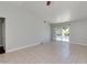 Living room with tile flooring, ceiling fan, sliding glass doors to pool area, and neutral wall colors at 4330 E Desert Trumpet Rd, Phoenix, AZ 85044