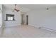 Large living room featuring tile flooring, a ceiling fan, and a pass-through to the kitchen area at 4330 E Desert Trumpet Rd, Phoenix, AZ 85044