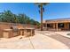 Backyard featuring outdoor kitchen, pergola and pool with lush landscaping at 43581 W Mccord Dr, Maricopa, AZ 85138