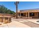 Backyard with pool, outdoor kitchen, solar panels and covered patio surrounded by lush landscaping at 43581 W Mccord Dr, Maricopa, AZ 85138