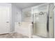Bathroom featuring a separate shower and soaking tub near a window at 43581 W Mccord Dr, Maricopa, AZ 85138