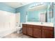 Bathroom features a shower-tub combo, single sink and wood cabinets at 43581 W Mccord Dr, Maricopa, AZ 85138