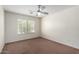 Bedroom with carpet, a ceiling fan, and a window providing natural light at 43581 W Mccord Dr, Maricopa, AZ 85138