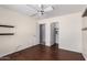 Bedroom showcasing hardwood floors, ceiling fan, and view to closet at 43581 W Mccord Dr, Maricopa, AZ 85138