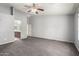 Carpeted bedroom with a ceiling fan and an attached bathroom at 43581 W Mccord Dr, Maricopa, AZ 85138