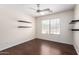 Bedroom with hardwood flooring, ceiling fan, and natural light from the window at 43581 W Mccord Dr, Maricopa, AZ 85138