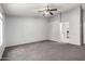Carpeted bedroom with a ceiling fan and neutral colored walls at 43581 W Mccord Dr, Maricopa, AZ 85138