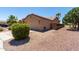 Attached two-car garage with desert landscaping, side yard access, and convenient driveway at 43581 W Mccord Dr, Maricopa, AZ 85138