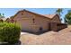 Two-car garage featuring desert landscaping, side yard access, and convenient driveway at 43581 W Mccord Dr, Maricopa, AZ 85138