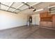 Attached garage with shelving, peg board, and water heater with plenty of room for parking at 43581 W Mccord Dr, Maricopa, AZ 85138