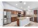 Open kitchen with stainless appliances, granite counters, and an island at 43581 W Mccord Dr, Maricopa, AZ 85138
