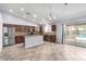 Well-lit kitchen with a center island, modern appliances, and backyard views at 43581 W Mccord Dr, Maricopa, AZ 85138