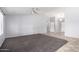 Spacious living room features neutral walls, carpet, and a ceiling fan at 43581 W Mccord Dr, Maricopa, AZ 85138