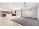 Open-concept living area with tile flooring and smooth transition to the kitchen and backyard at 43581 W Mccord Dr, Maricopa, AZ 85138
