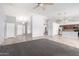 Spacious open-concept living area featuring tile flooring flowing into the kitchen at 43581 W Mccord Dr, Maricopa, AZ 85138