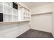 Walk-in closet features organizers and shelves for ample storage at 43581 W Mccord Dr, Maricopa, AZ 85138