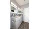 Bathroom featuring a double sink vanity with granite countertop and a tiled backsplash and wood-look flooring at 4437 E Villa Theresa Dr, Phoenix, AZ 85032