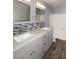 Bathroom featuring a double sink vanity with granite countertop and a tiled backsplash and shower at 4437 E Villa Theresa Dr, Phoenix, AZ 85032