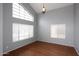 Inviting bedroom features hardwood floors, large windows, and a modern chandelier at 4437 E Villa Theresa Dr, Phoenix, AZ 85032