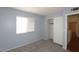 Bedroom with neutral carpet, light blue walls, a closet with sliding doors, and a window providing natural light at 4437 E Villa Theresa Dr, Phoenix, AZ 85032