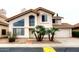 Beige two-story home with a red tile roof, desert landscaping, and a two car garage at 4437 E Villa Theresa Dr, Phoenix, AZ 85032