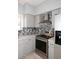 Updated kitchen features stainless steel appliances, mosaic backsplash, granite countertops, and modern cabinetry at 4437 E Villa Theresa Dr, Phoenix, AZ 85032