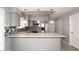 Updated kitchen features stainless steel appliances, mosaic backsplash, granite countertops, and modern cabinetry at 4437 E Villa Theresa Dr, Phoenix, AZ 85032