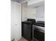 Convenient laundry area with modern washer and dryer units and built in shelving at 4437 E Villa Theresa Dr, Phoenix, AZ 85032