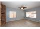 Spacious living room with a stone fireplace, tiled floor, and large windows bringing in natural light at 4437 E Villa Theresa Dr, Phoenix, AZ 85032