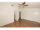 Primary bedroom featuring a ceiling fan, hardwood floors and access to bathroom and closet at 4437 E Villa Theresa Dr, Phoenix, AZ 85032