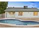 Backyard view of the home and kidney shaped in-ground pool at 4611 E Fremont St, Phoenix, AZ 85042