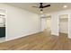 Bright bedroom featuring modern ceiling fan, wood-look floors, and access to ensuite bathroom and closet at 4611 E Fremont St, Phoenix, AZ 85042