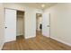 Bedroom with hardwood floors, closet, and a view into the bathroom at 4611 E Fremont St, Phoenix, AZ 85042
