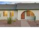 Close up of the desert landscaped front entrance featuring a unique arched doorway at 4611 E Fremont St, Phoenix, AZ 85042