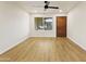 Bright room featuring hardwood floors, a ceiling fan, and a classic wooden door at 4611 E Fremont St, Phoenix, AZ 85042