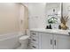Well-lit bathroom with a modern vanity, quartz countertop, and neutral accents at 4708 N 41St Pl, Phoenix, AZ 85018