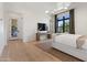 Well-lit bedroom with wood floors, neutral bedding, and open floor plan at 4708 N 41St Pl, Phoenix, AZ 85018