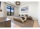 Bright bedroom features a modern bed, stylish rug, and large window overlooking a serene outdoor view at 4708 N 41St Pl, Phoenix, AZ 85018