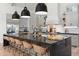 Island with black countertops, wicker bar stools and premium stainless appliances at 4708 N 41St Pl, Phoenix, AZ 85018