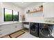Well-organized laundry room with modern appliances, countertop space, and storage at 4708 N 41St Pl, Phoenix, AZ 85018