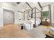 Sun-filled primary bedroom with wood flooring, large window and four-poster bed at 4708 N 41St Pl, Phoenix, AZ 85018
