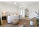 Bright, stylish bedroom with a large bed, modern lighting, and a beautiful decorative mirror at 4708 N 41St Pl, Phoenix, AZ 85018