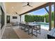 Covered outdoor dining area with a long table, chairs, and views of the pool and backyard at 4708 N 41St Pl, Phoenix, AZ 85018